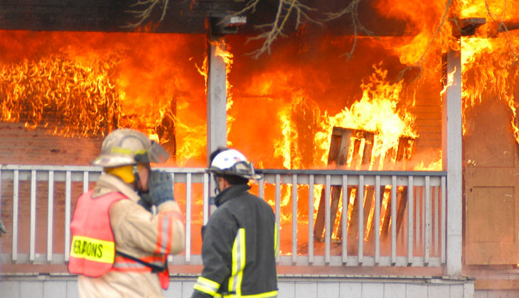 Fire fighters outside a burning home